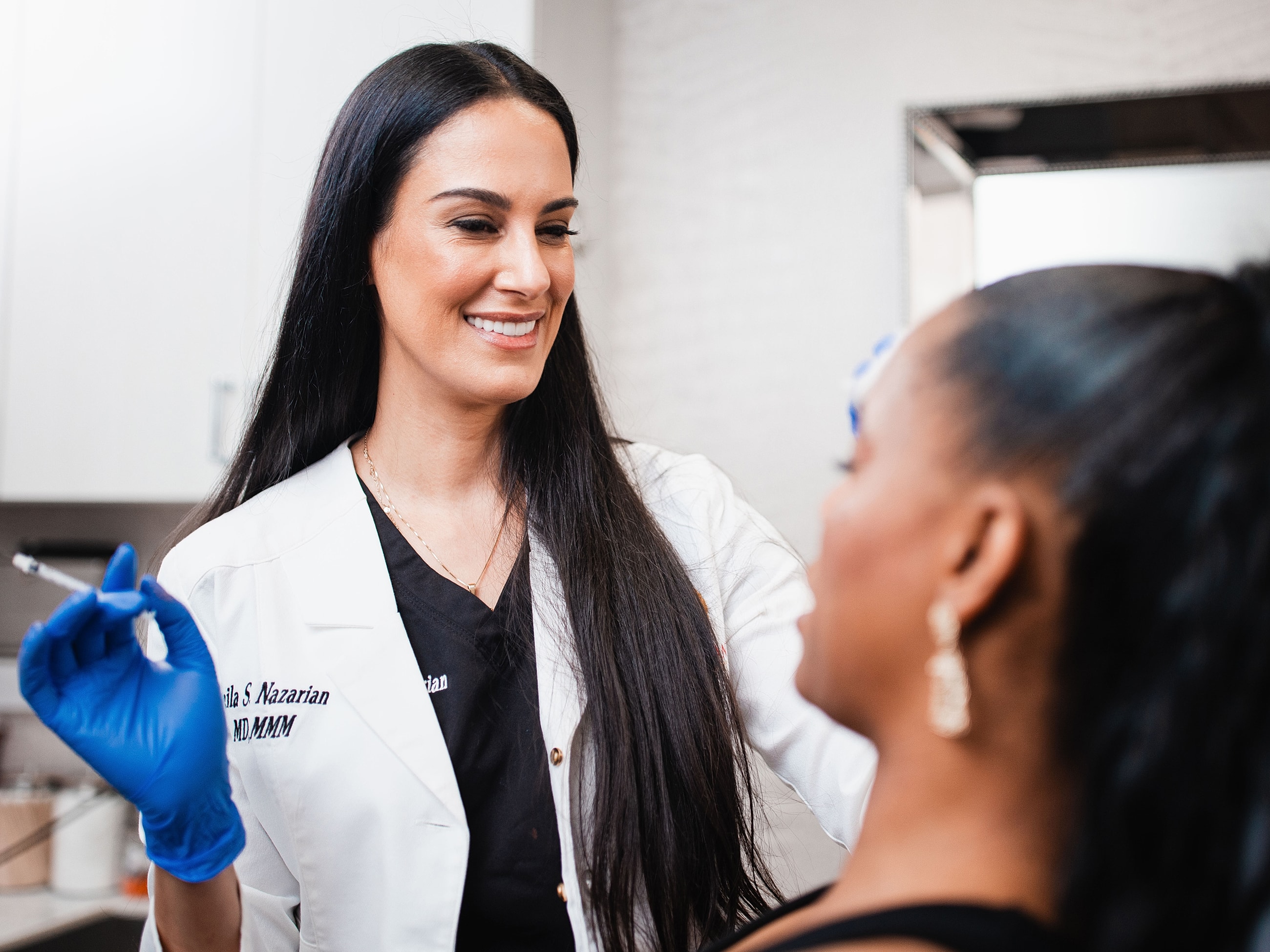 Woman in stylish outfit with flower accessory.