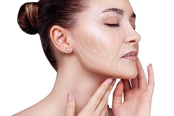 Model with facial contour lines on skin.