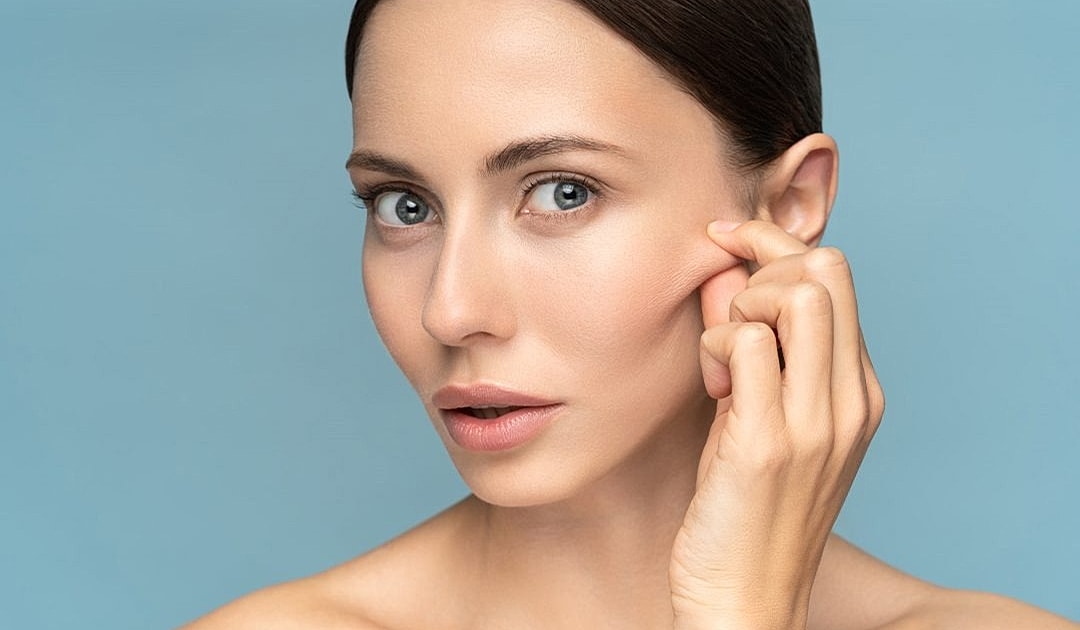 Woman with beautiful skin on blue background.