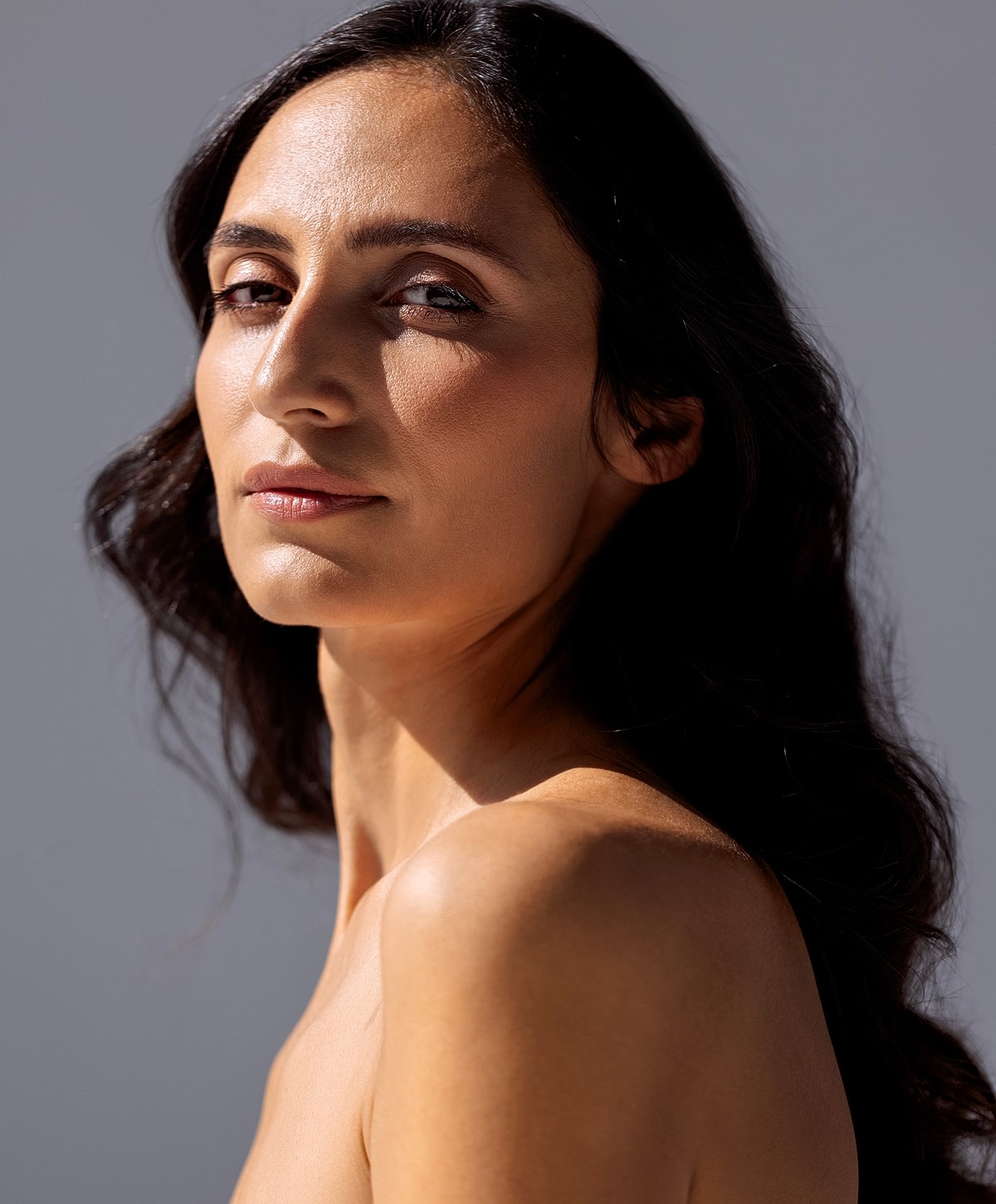 Woman walking up stairs in fitted jeans.