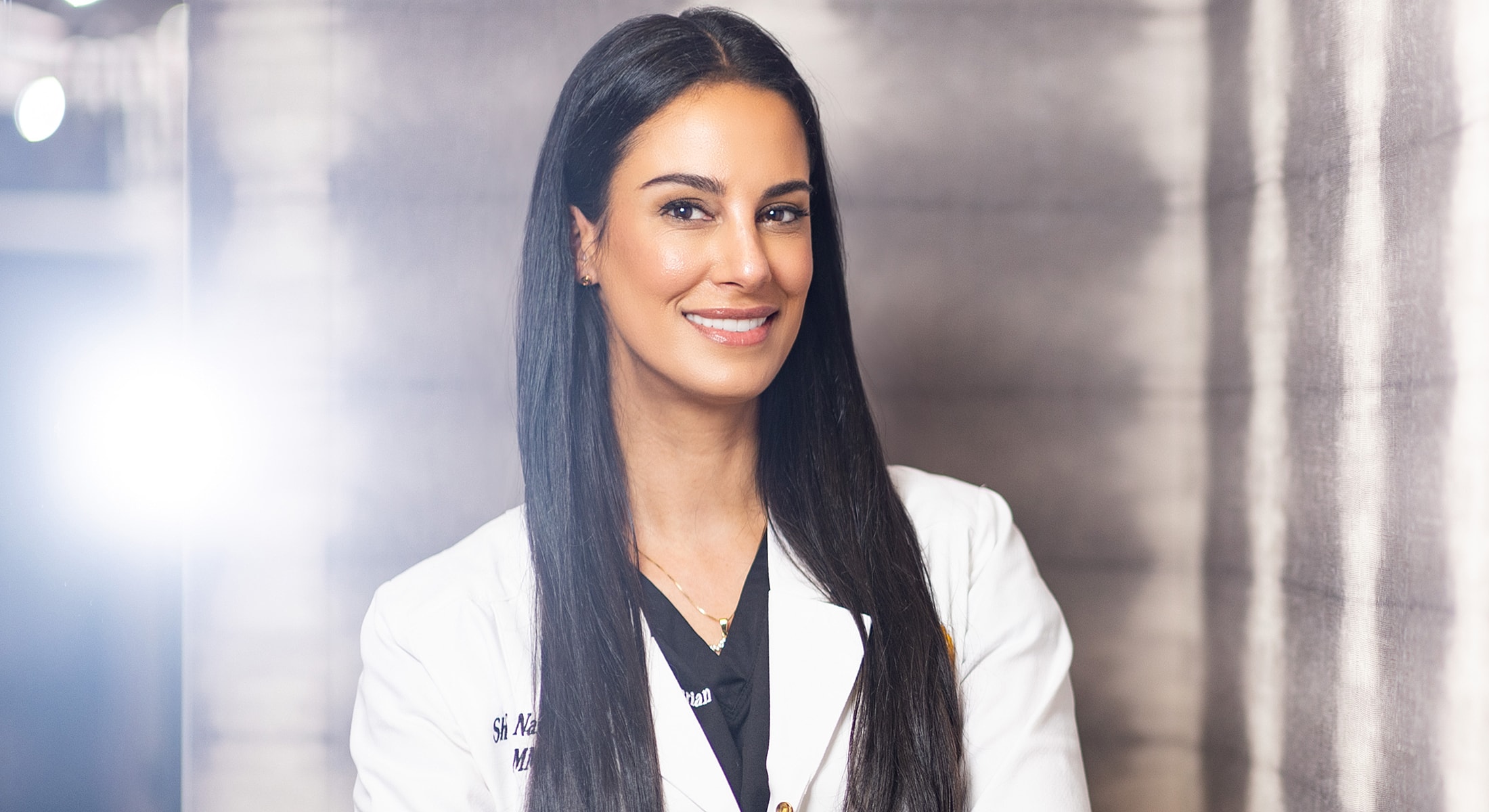 Smiling doctor in a professional white coat.