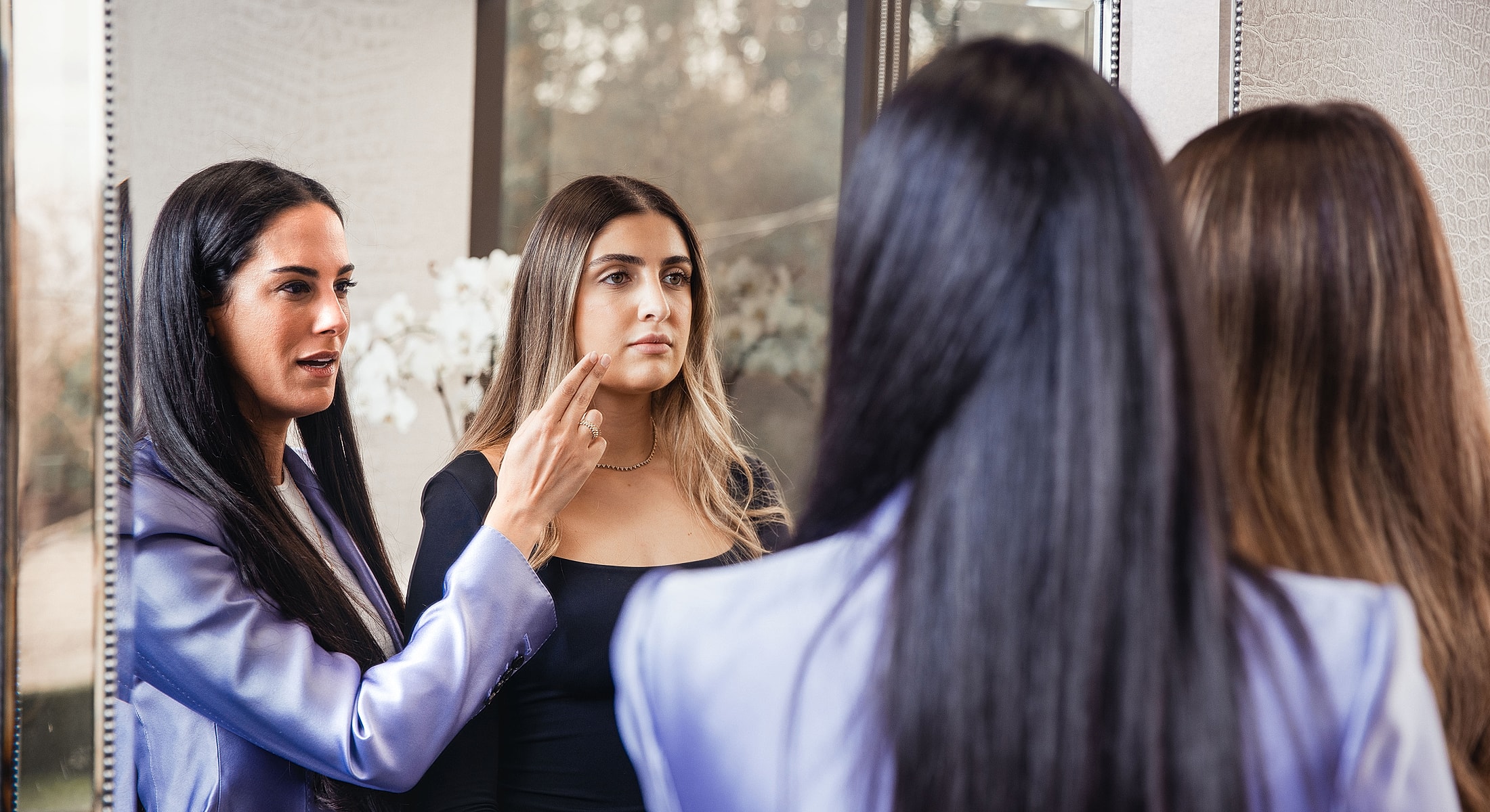 Consultation between Dr. Nazarian Beverly Hills plastic surgeon and a patient in front of a mirror.