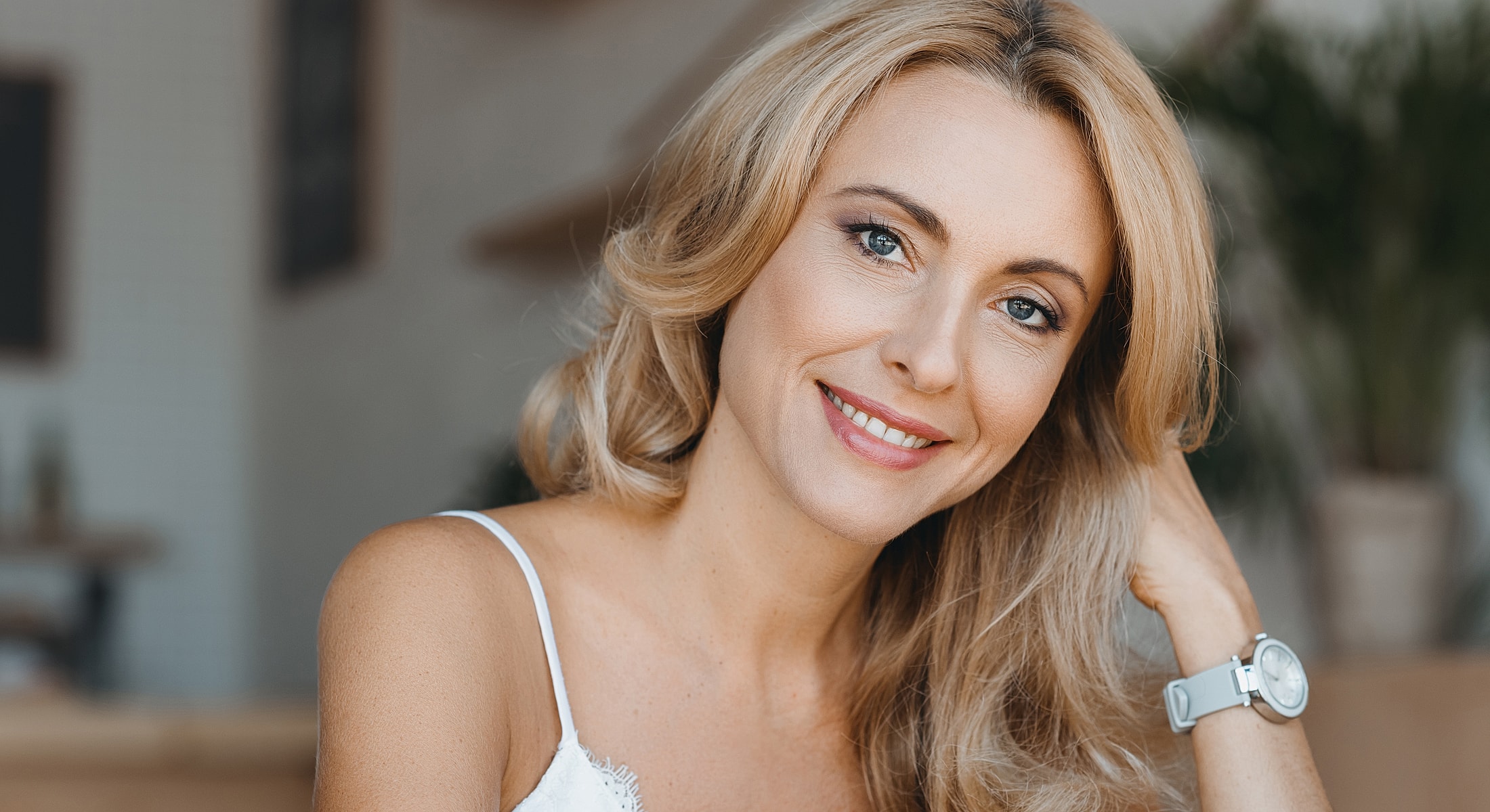 Smiling woman with blonde hair in bright setting