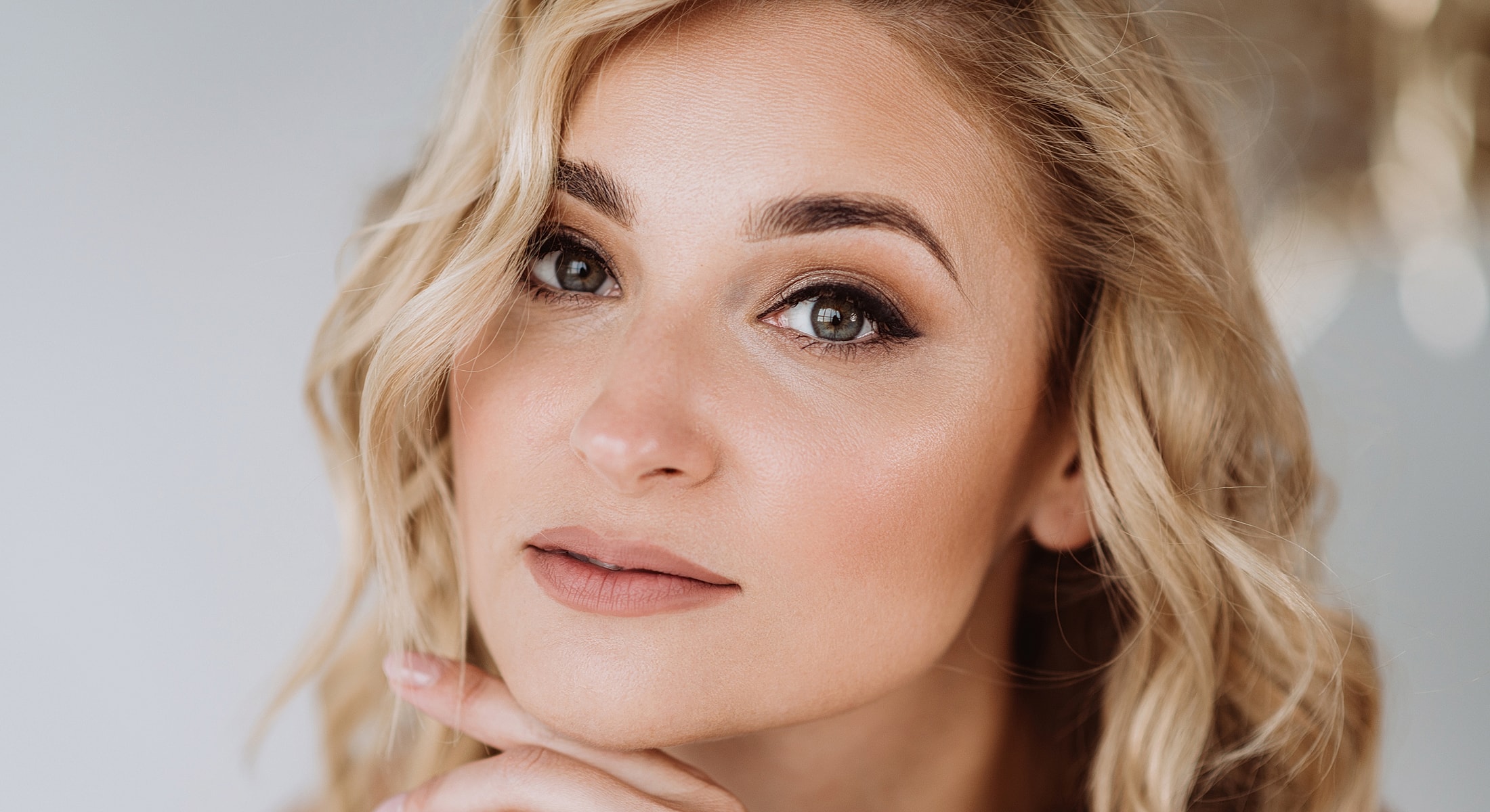 Close-up of a woman with wavy blonde hair.